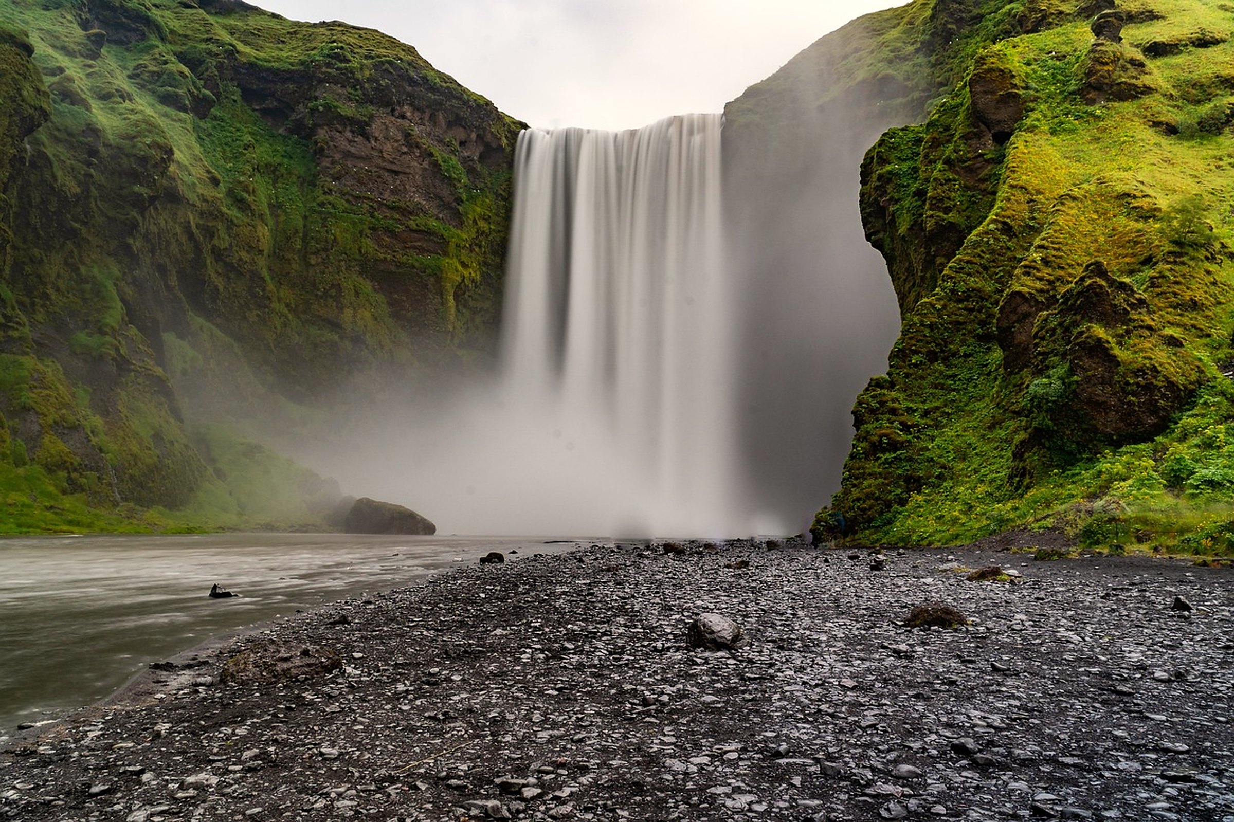 A waterfall between mossy cliffs in Iceland